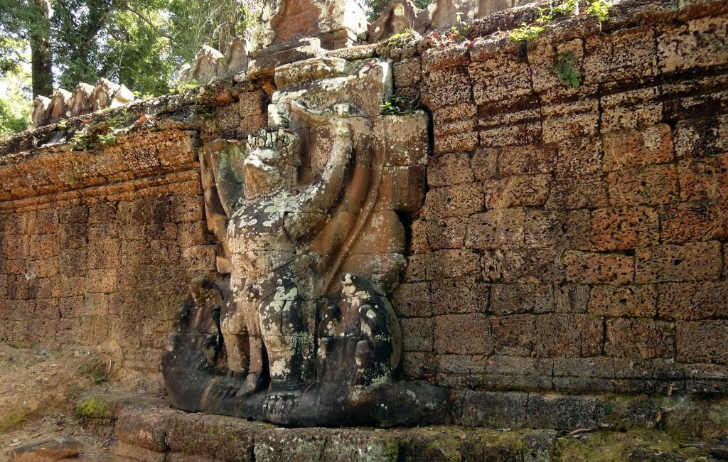 A stone carving of a garuda, a mythical bird in Hinduism and Buddhism, on the wall of Preah Khan Temple. A stone carving of a garuda, a mythical bird in Hinduism and Buddhism, on the wall of Preah Khan Temple.